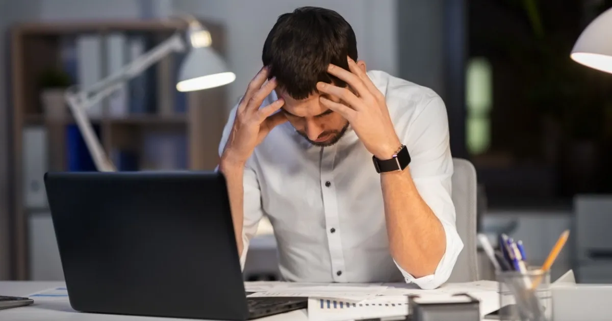 Man stressed at his desk working from home